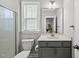 Well-lit bathroom featuring a walk-in shower, toilet, vanity with sink, and modern fixtures, offering a clean and functional space at 6036 Balance Ct, Raleigh, NC 27616