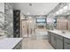 Stylish bathroom features gray wallpaper, dual vanities, walk-in shower, a large soaking tub, and modern fixtures at 6036 Balance Ct, Raleigh, NC 27616