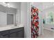 Bathroom featuring a gray vanity with a sink and a colorful shower curtain at 6036 Balance Ct, Raleigh, NC 27616