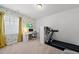 Bright bedroom with patterned wallpaper, a window with curtains, and a treadmill at 6036 Balance Ct, Raleigh, NC 27616
