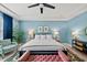Bright bedroom features stylish furniture, large window, blue walls, and modern decor for a relaxing retreat at 6036 Balance Ct, Raleigh, NC 27616