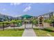 Community garden area with a shelter, several garden plots, and wooden shelving at 6036 Balance Ct, Raleigh, NC 27616