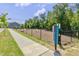 Exterior shot of the community dog park area with green grass and a sidewalk at 6036 Balance Ct, Raleigh, NC 27616