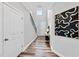 Elegant hallway showcasing hardwood floors, white trim, and a stylish decor leading to the front door at 6036 Balance Ct, Raleigh, NC 27616