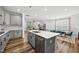 Bright, open kitchen featuring a large island, stainless steel appliances, and hardwood floors at 6036 Balance Ct, Raleigh, NC 27616