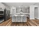 Modern kitchen with stainless steel appliances, quartz countertops, and a spacious island with seating at 6036 Balance Ct, Raleigh, NC 27616