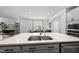 Modern kitchen features a large island with a stainless steel sink and open floorplan at 6036 Balance Ct, Raleigh, NC 27616
