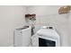 Laundry room with modern washer, dryer, and storage shelves at 6036 Balance Ct, Raleigh, NC 27616