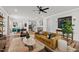 Open-concept living room showcasing stylish decor, hardwood floors, modern lighting, and access to the dining and kitchen areas at 6036 Balance Ct, Raleigh, NC 27616