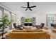 Spacious living room with ceiling fan, hardwood floors, modern shelving and comfortable seating at 6036 Balance Ct, Raleigh, NC 27616