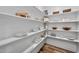 Walk-in pantry with white shelving, providing ample storage space for groceries at 6036 Balance Ct, Raleigh, NC 27616