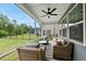 Cozy covered patio with comfortable seating and ceiling fan at 6036 Balance Ct, Raleigh, NC 27616