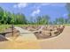 Community playground with concrete sidewalks, rock formations and slide at 6036 Balance Ct, Raleigh, NC 27616