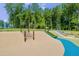 Community playground featuring slides, climbing net, and wood chip ground covering at 6036 Balance Ct, Raleigh, NC 27616