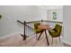 Cozy landing area with a table and two chairs beside the stairwell and a view of the outside at 6036 Balance Ct, Raleigh, NC 27616