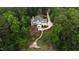 Aerial view of a two-story home surrounded by lush trees, featuring a winding driveway at 636 Pendleton Lake Rd, Raleigh, NC 27614