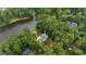 A beautiful lakeside home nestled among lush trees and greenery is revealed in this aerial view at 636 Pendleton Lake Rd, Raleigh, NC 27614