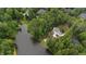 Majestic aerial view of lakeside home surrounded by forest and greenery, a nature escape at 636 Pendleton Lake Rd, Raleigh, NC 27614