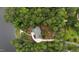 Aerial view of a picturesque lakeside property with lush greenery and mature trees at 636 Pendleton Lake Rd, Raleigh, NC 27614