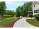 Expansive backyard with a lakeside view and mature trees, offering a private retreat at 636 Pendleton Lake Rd, Raleigh, NC 27614