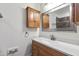 Bathroom with granite vanity, storage cabinet, and framed mirror at 636 Pendleton Lake Rd, Raleigh, NC 27614