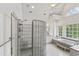 Inviting bathroom featuring shower, soaking tub, and decorative glass block at 636 Pendleton Lake Rd, Raleigh, NC 27614