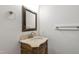 Elegant bathroom vanity with carved details, marble countertop, and framed mirror at 636 Pendleton Lake Rd, Raleigh, NC 27614