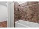 Bathroom with a white tub with tiled wall and shower head at 636 Pendleton Lake Rd, Raleigh, NC 27614