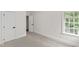 Bedroom with neutral carpet, a window and white doors at 636 Pendleton Lake Rd, Raleigh, NC 27614