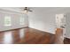 Bright bedroom with hardwood floors, ceiling fan, and ensuite bathroom access at 636 Pendleton Lake Rd, Raleigh, NC 27614