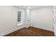 Bedroom with wood-look flooring, white walls, baseboards, and white frame window with natural light at 636 Pendleton Lake Rd, Raleigh, NC 27614