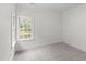 Bright bedroom featuring neutral carpet and a window with backyard view at 636 Pendleton Lake Rd, Raleigh, NC 27614