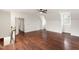 Large bonus room with hardwood floors, access to landing, and bright white paint at 636 Pendleton Lake Rd, Raleigh, NC 27614
