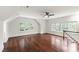 Bright bonus room featuring hardwood floors, a ceiling fan, and large windows at 636 Pendleton Lake Rd, Raleigh, NC 27614