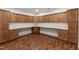 Bonus room with white countertop, cabinets, and wood-look flooring at 636 Pendleton Lake Rd, Raleigh, NC 27614