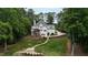 Charming two-story house with a screened porch, surrounded by lush greenery and a stone pathway at 636 Pendleton Lake Rd, Raleigh, NC 27614