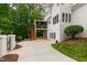 Back exterior with a screened-in porch, multiple windows, and manicured landscaping at 636 Pendleton Lake Rd, Raleigh, NC 27614