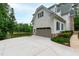 Attached two-car garage with a concrete driveway and picturesque lake view at 636 Pendleton Lake Rd, Raleigh, NC 27614