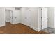 Hallway with multiple doors and wood-look flooring at 636 Pendleton Lake Rd, Raleigh, NC 27614
