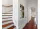 Hallway with stairway, mirror, and arched doorway at 636 Pendleton Lake Rd, Raleigh, NC 27614