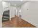 Hallway with staircase, neutral walls and wood-look flooring at 636 Pendleton Lake Rd, Raleigh, NC 27614