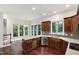 Kitchen boasts wood cabinets, granite counters, stainless appliances and hardwood floors, enhanced by natural light at 636 Pendleton Lake Rd, Raleigh, NC 27614