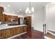 Bright kitchen features wood cabinets, stainless appliances, hardwood floors, and a breakfast area at 636 Pendleton Lake Rd, Raleigh, NC 27614