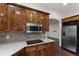 Charming kitchen with stylish wood cabinets, stainless microwave, cooktop, granite countertop, and hardwood floors at 636 Pendleton Lake Rd, Raleigh, NC 27614