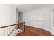 Hall landing featuring hardwood floors, white trim and a wood banister staircase at 636 Pendleton Lake Rd, Raleigh, NC 27614