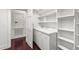 Practical laundry area with storage shelves, sink, and ample counter space at 636 Pendleton Lake Rd, Raleigh, NC 27614