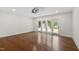 Bright living room with hardwood floors and access to the patio through glass doors at 636 Pendleton Lake Rd, Raleigh, NC 27614