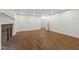 Large living room featuring hardwood floors, a brick fireplace, and neutral paint at 636 Pendleton Lake Rd, Raleigh, NC 27614