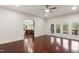 Open-concept living room with hardwood floors, leading to the kitchen and a deck at 636 Pendleton Lake Rd, Raleigh, NC 27614