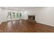 Spacious living room with hardwood floors, a brick fireplace, and access to the outdoor patio at 636 Pendleton Lake Rd, Raleigh, NC 27614